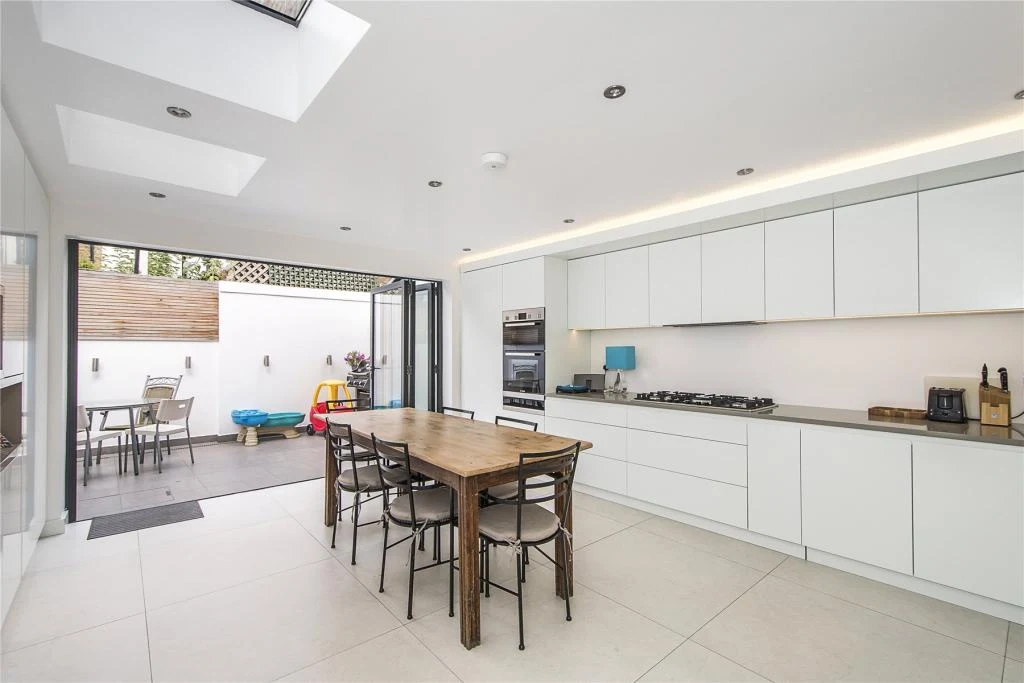 Completed Fulham rear extension with an open-plan kitchen and dining space, rooflights and wide garden doors